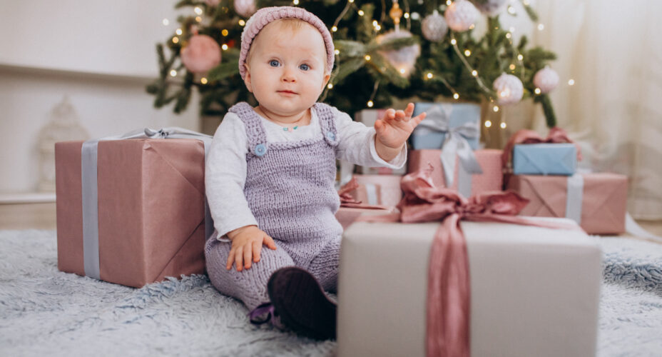 cute-little-baby-girl-sitting-by-christmas-presents